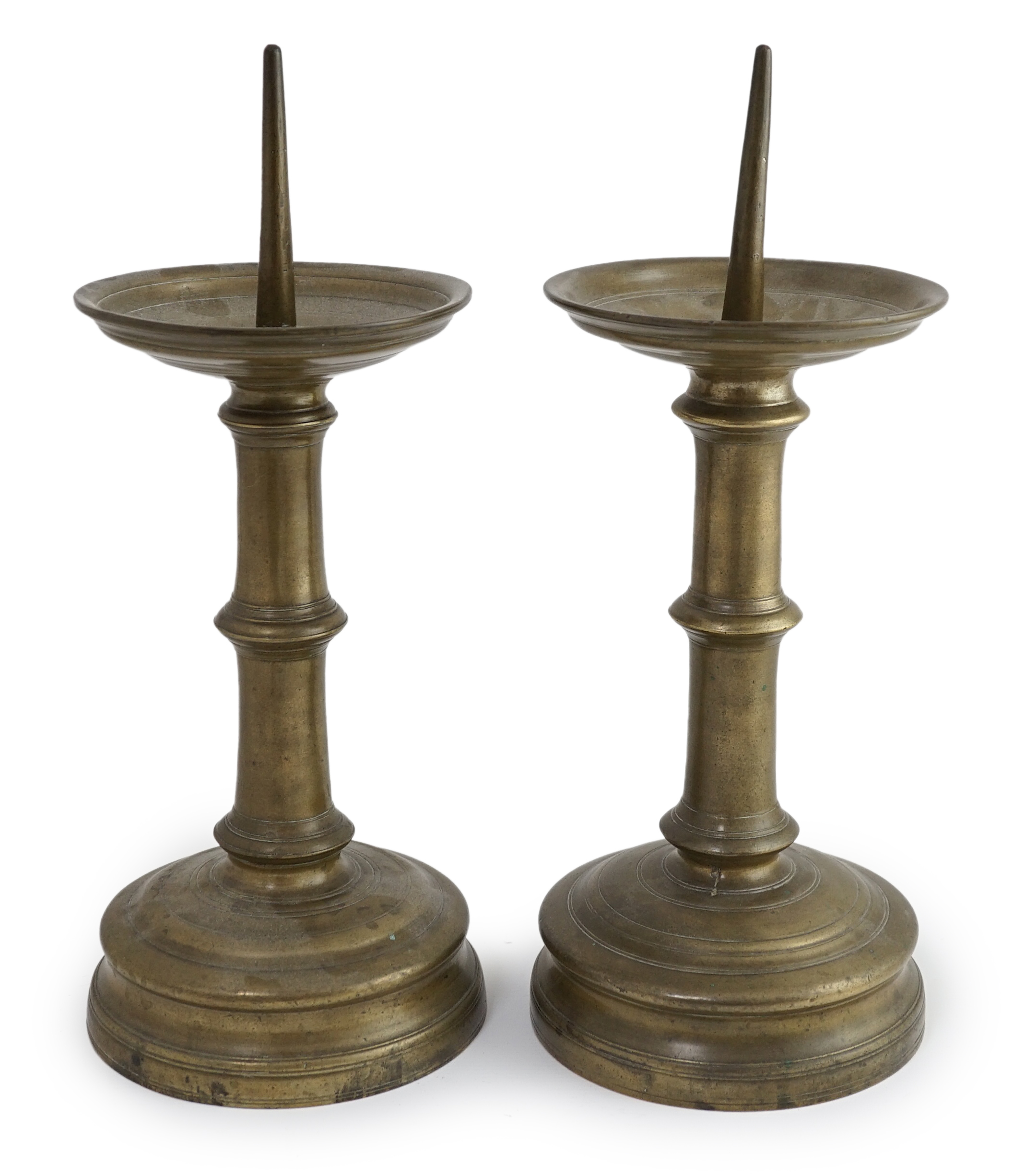 A pair of 16th century bell metal pricket candlesticks